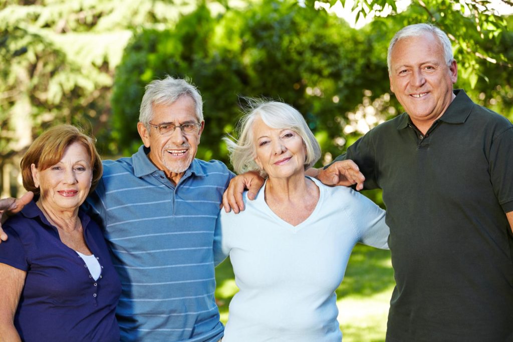 two old couples hands over shoulder