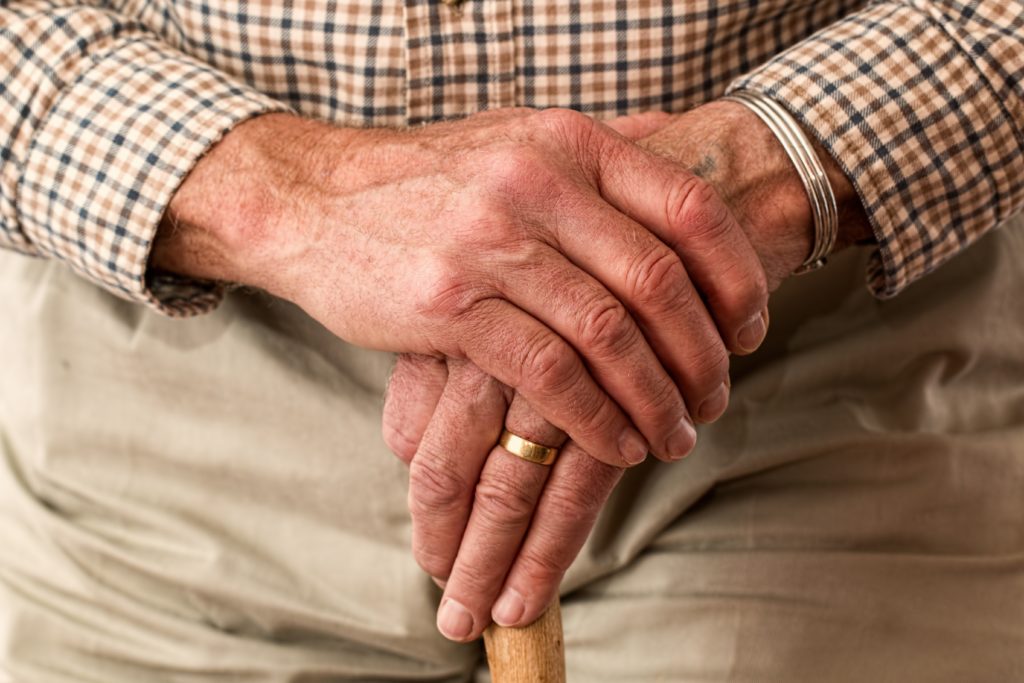 Aged man holding a cane