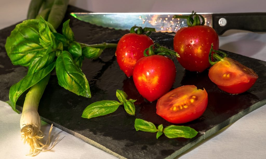 Red tomatoes on cutting board.