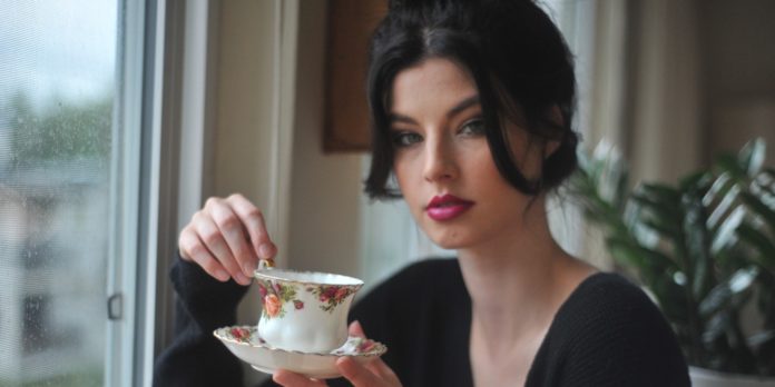 A woman holding a cup of tea