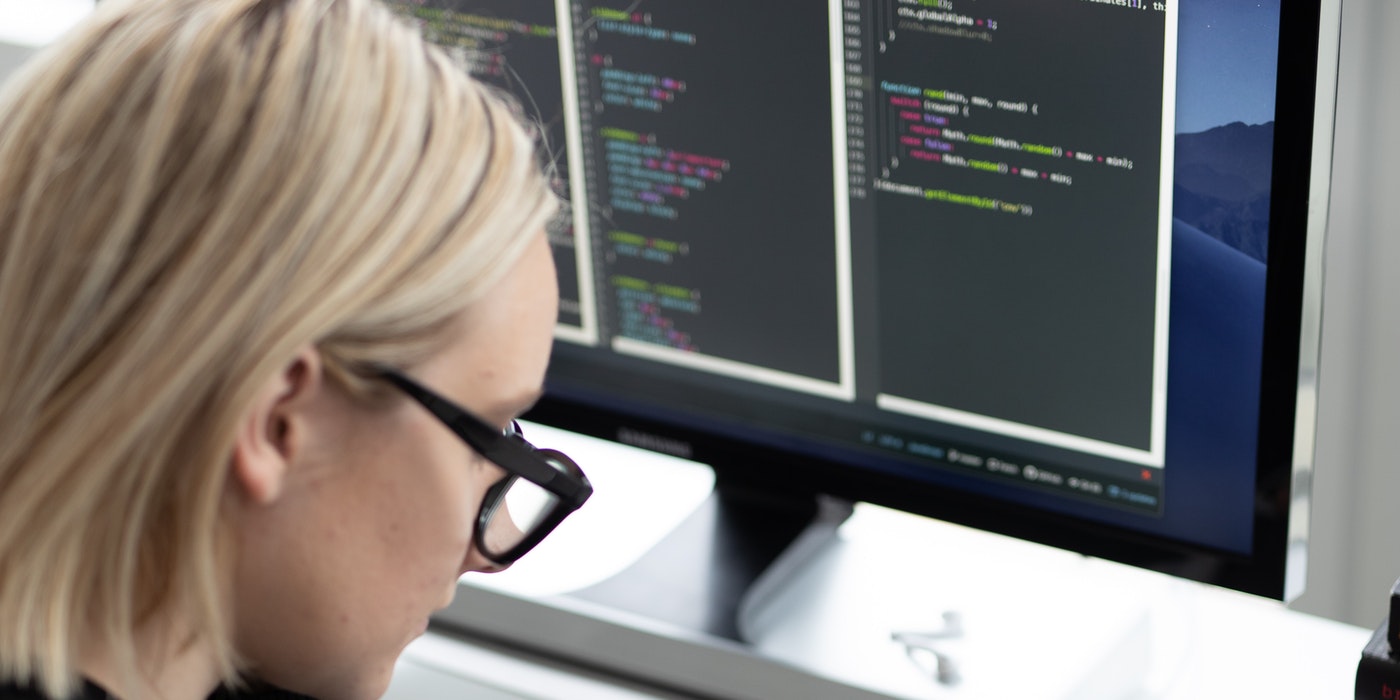 A bespectacled lady using a computer