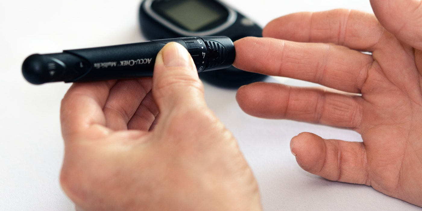 An image of someone testing for blood sugar