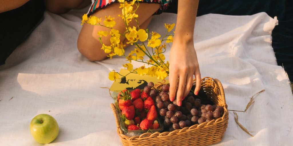 Picking a fruit from a basket