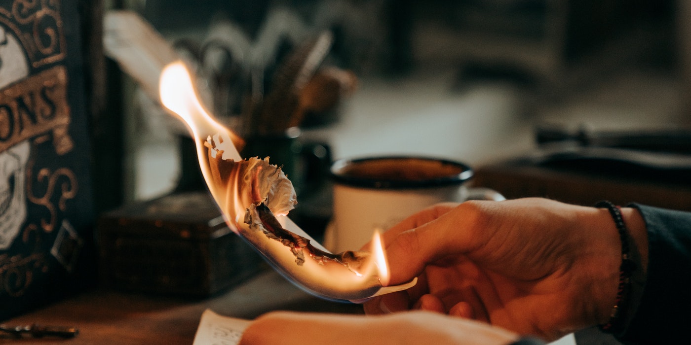 hand on a burning paper